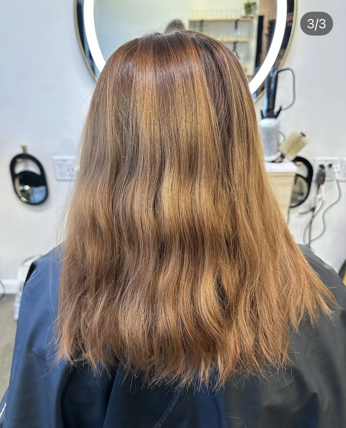 Back view of long warm brunette hair with dimensional highlights and soft natural texture.