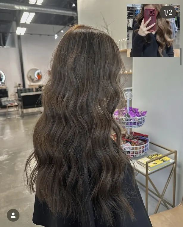 Long brunette hair styled in soft waves with rich tone and shine.